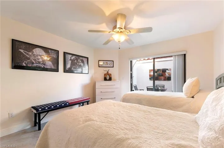 Bedroom featuring access to exterior and a ceiling fan