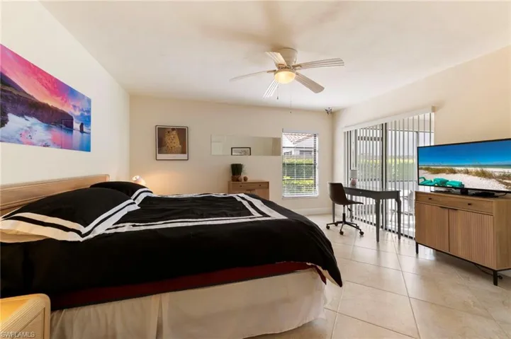 Bedroom featuring light tile patterned floors and ceiling fan