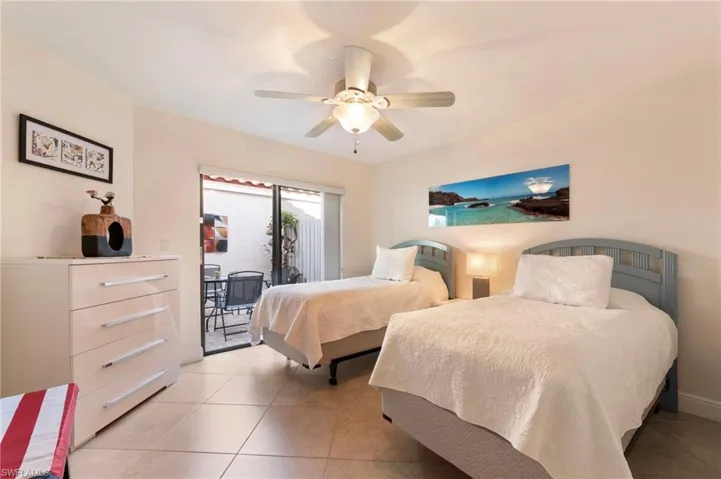 Bedroom with access to outside, tile patterned flooring, and ceiling fan
