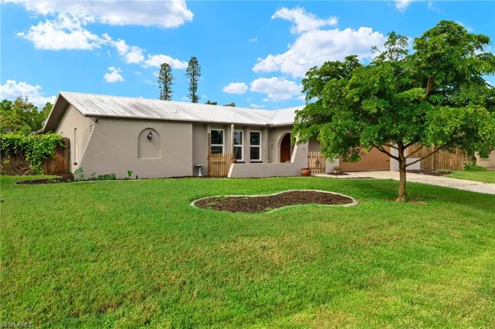Single story home with a front yard