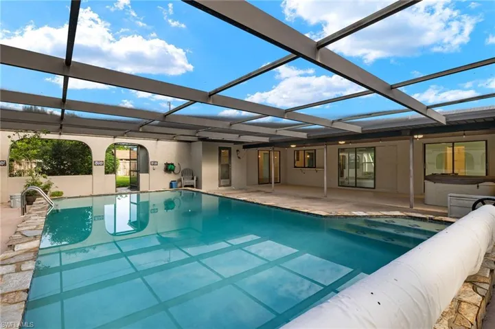 View of pool with a patio area and a lanai