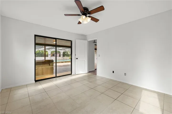 Spare room featuring ceiling fan and light tile patterned floors