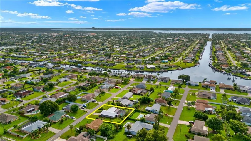 Birds eye view of property with a water view