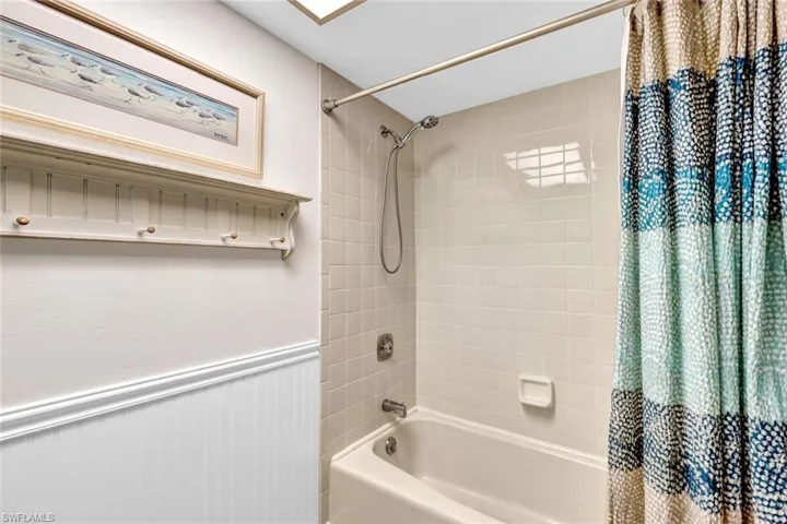 Bathroom featuring shower / bath combination with curtain