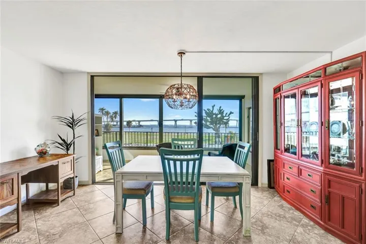 Dining space with light tile patterned floors and a chandelier