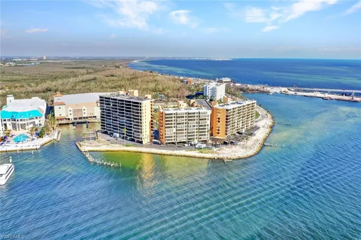 Birds eye view of property with a water view
