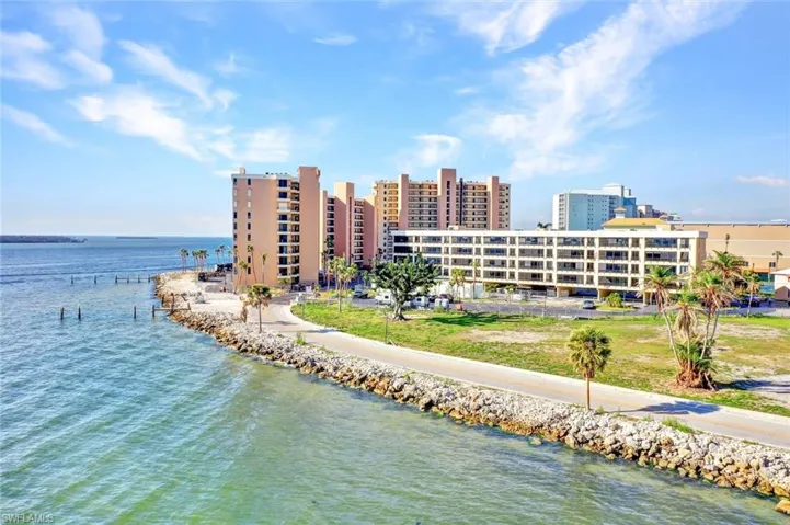 Birds eye view of property with a water view