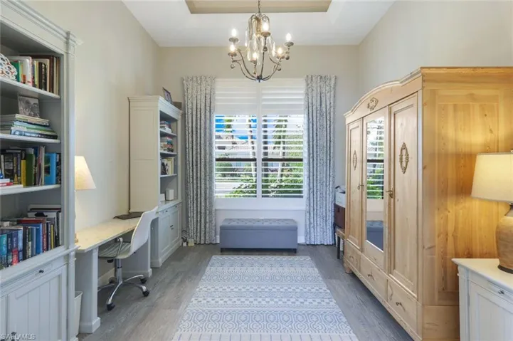 The perfect office does exist, complete with built-in book shelves, plantation shutters and tray ceiling detail