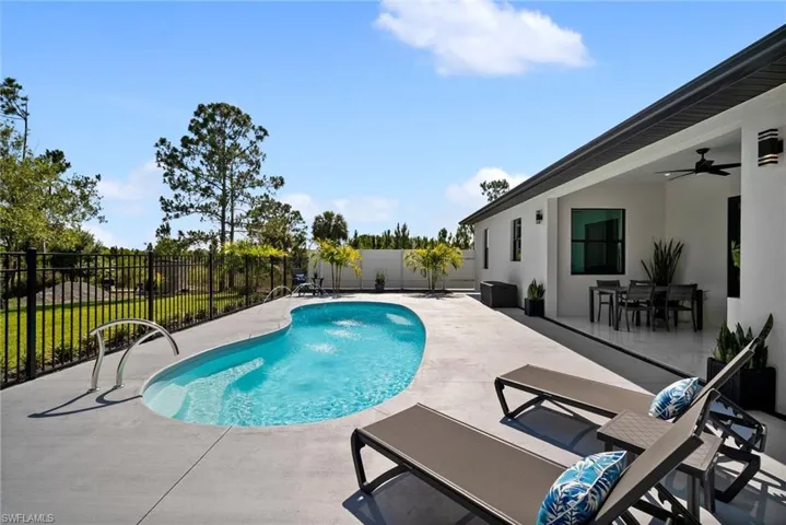 View of pool featuring a patio area and ceiling fan