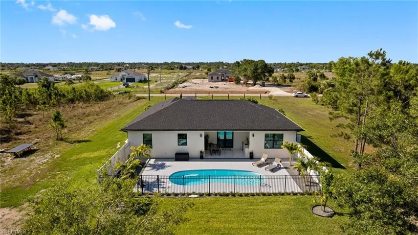 View of swimming pool featuring a patio area and a lawn