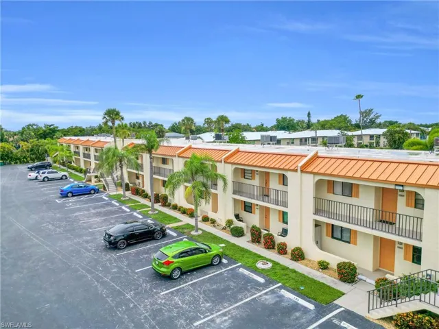 View of property featuring uncovered parking