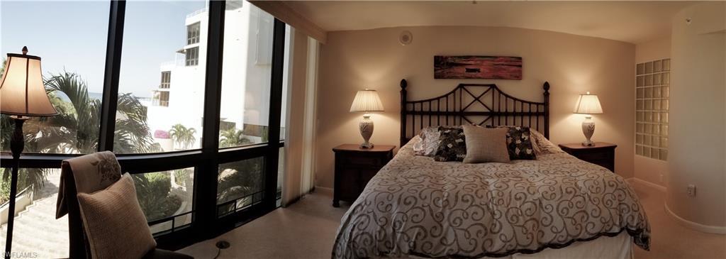 Wide floor to ceiling windows, luxurious bedding and peek a boo to the master bath