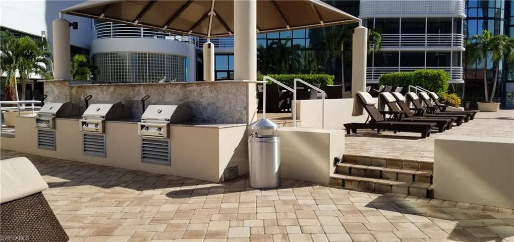 Gass grilles for your use, sun lounges and a bar area on a terrace overlooking the pool below.