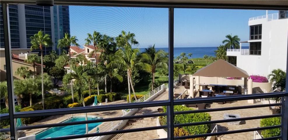 Open Balcony Views of the pool and gulf. BBQ area to the right side on elevated deck with firepit.