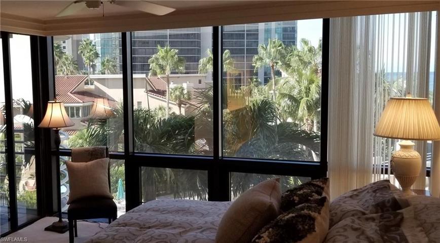. . . Another angle of views from the wall to wall windows in the Master bedroom with tropical landscaping and a peek at the pool