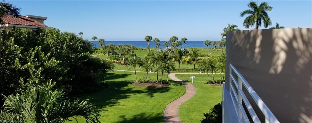 Spacious landscaped grounds with a paved walkway to the beachfront.