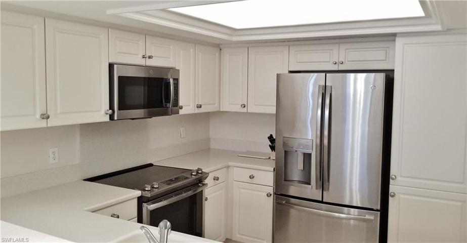 Well equipped kitchen with stainless steel appliances and ample storage and countertop