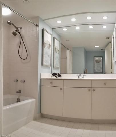 Guest bathroom with spacious vanity and tub shower with double shower heads