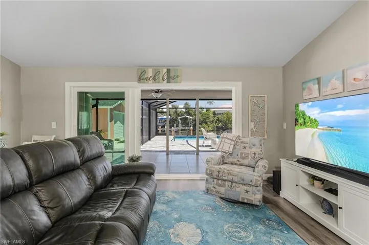 Living room with impact sliders to pool and lanai.