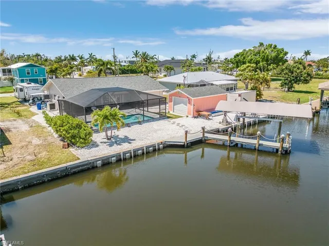 Aerial of home, pool, dock, and lift, with detached garage!