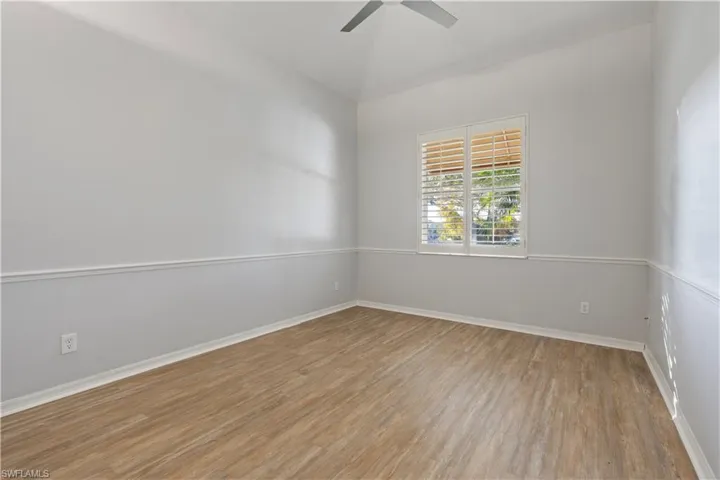 Unfurnished room featuring light wood-type flooring and ceiling fan