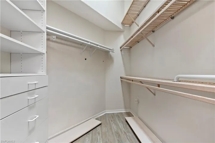 Spacious closet with light wood-type flooring