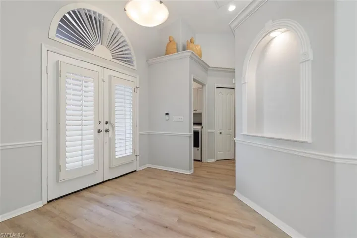 Entryway with french doors, light wood-type flooring, and washer / clothes dryer