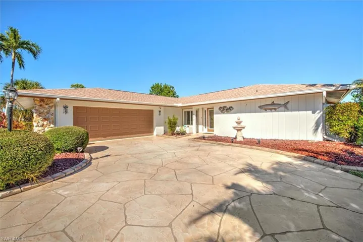 Single story home with concrete driveway, a garage, and a shingled roof