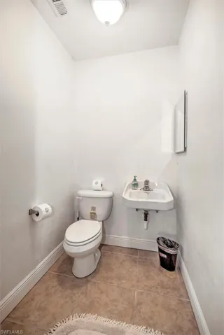 Bathroom featuring baseboards and light tile patterned flooring