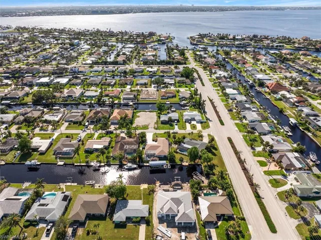 Aerial view of property's location with nearby suburban area and a nearby body of water