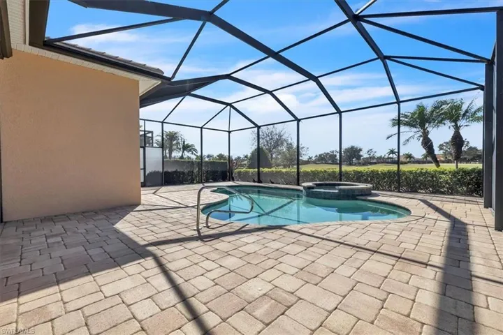 Integrated pool / hot tub featuring a patio, a sunroom, and a lanai