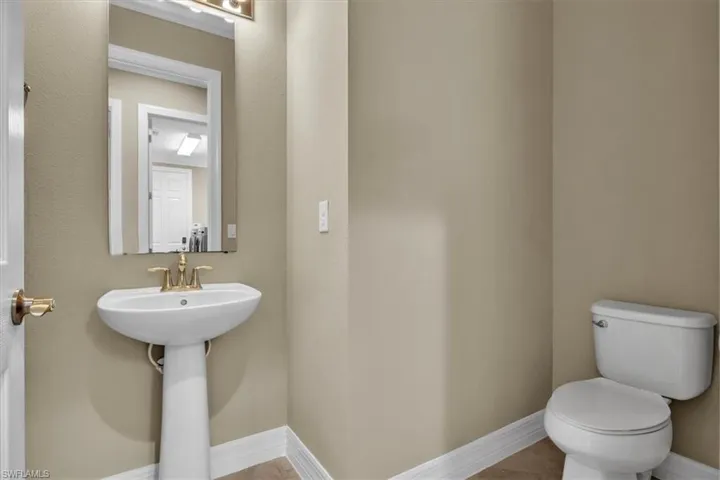 Bathroom featuring baseboards and toilet