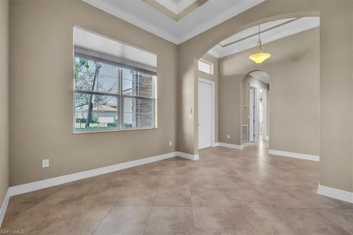 Entrance foyer featuring arched walkways and ornamental molding