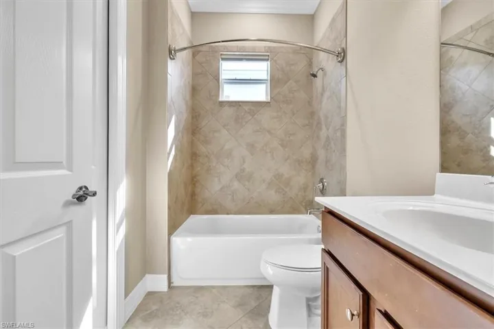 Bathroom with vanity and bathtub / shower combination