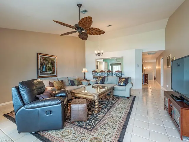 Living room featuring high ceiling in direction the kitchen