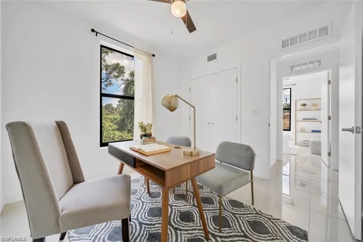 Office with visible vents, baseboards, and a ceiling fan