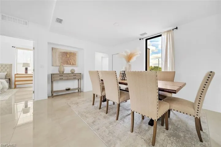 Dining space with visible vents and light tile patterned flooring