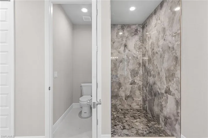 Bathroom featuring a tile shower and recessed lighting