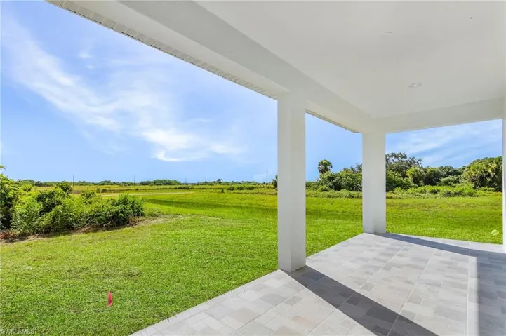 View of grassy yard featuring a patio and a view of rural / pastoral area