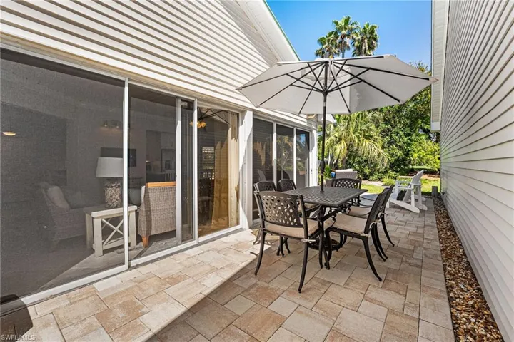The patio is pavered and runs the length of the home.