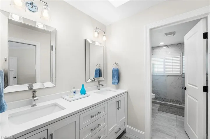 Stunning quartz countertops on the dual comfort height vanity in your primary ensuite bathroom.