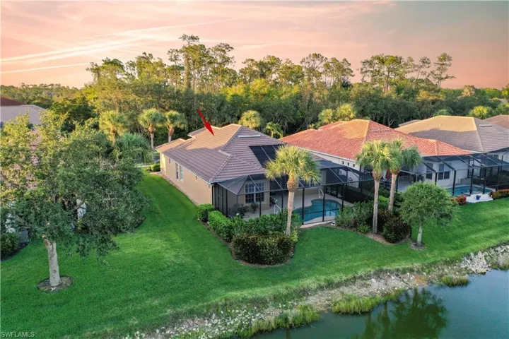 Aerial view at dusk featuring a water view