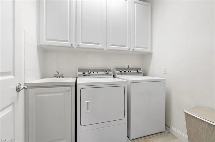 This laundry room is located on the second level of the house. It has a wash tub and is accessible from the hallway.