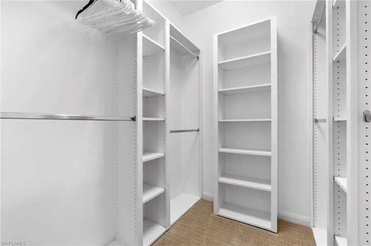 This custom closet has built-in shelving that makes it easy to organize your clothes and accessories.