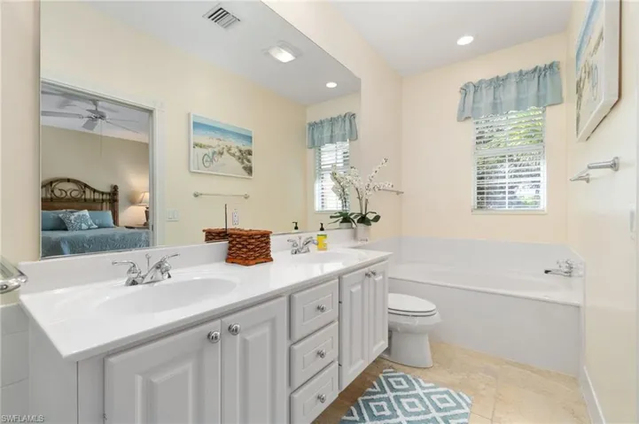 This is an upstairs bathroom. It has a shower and a toilet. It is an en-suite bathroom, which means that it is attached to a bedroom.