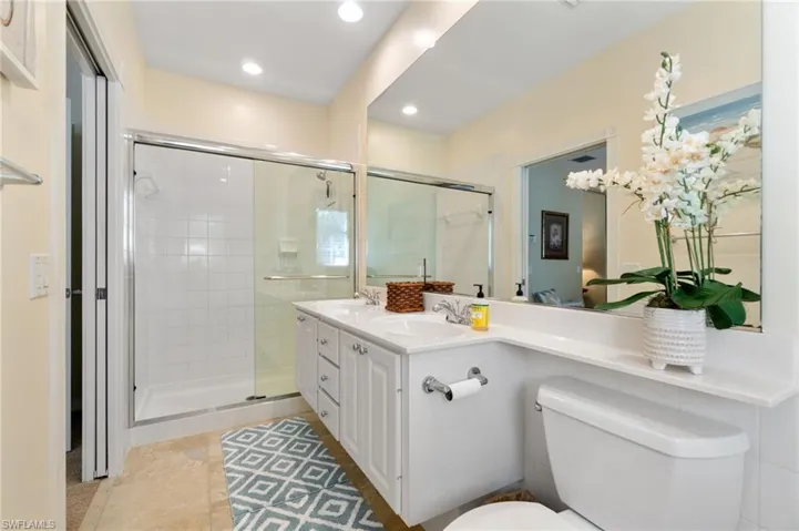 This is an upstairs bathroom. It has a shower and a toilet. It is an en-suite bathroom, which means that it is attached to a bedroom.