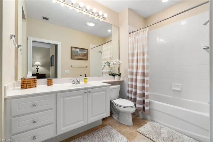 This is an upstairs bathroom. It has a shower and a toilet. It is an en-suite bathroom, which means that it is attached to a bedroom.