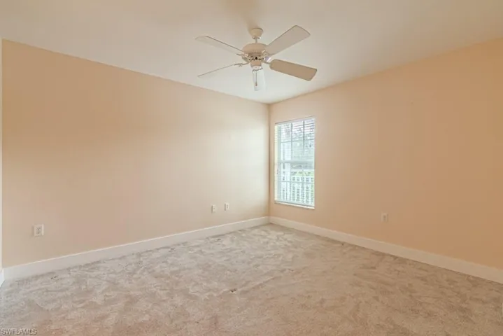 Spare room with carpet floors and ceiling fan