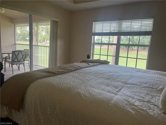 Bedroom with carpet and access to exterior