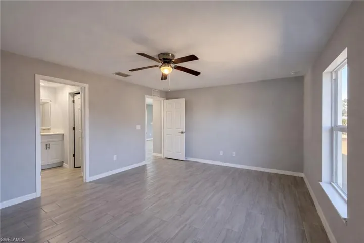 Unfurnished bedroom with ceiling fan and light wood-style floors